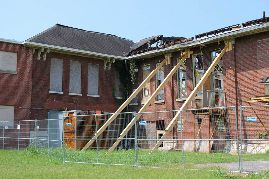 Current condition: roof damage and temporary structural bracing